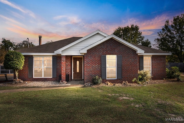 ranch-style house featuring a lawn