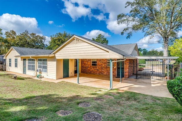 rear view of property with a lawn and a patio