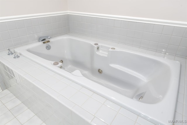 bathroom with tiled bath and tile patterned flooring