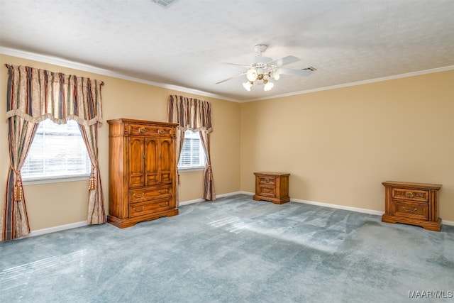 unfurnished bedroom with ornamental molding, ceiling fan, and carpet floors