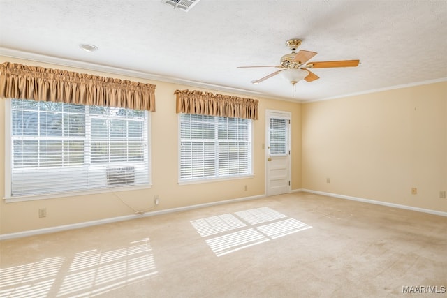 carpeted empty room with ceiling fan, a textured ceiling, and ornamental molding