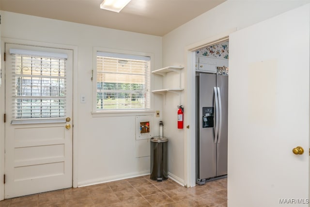 doorway to outside featuring light tile patterned floors