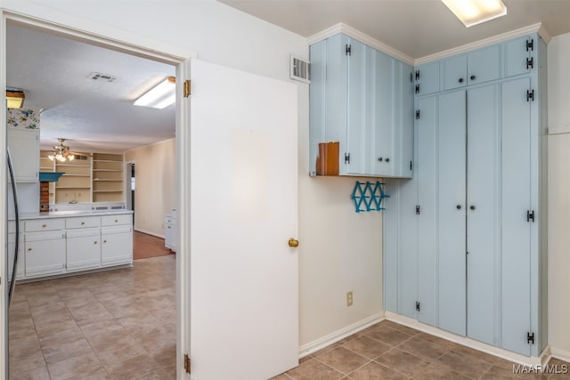 clothes washing area with light tile patterned floors and ceiling fan