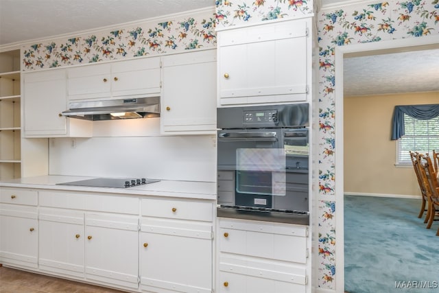 kitchen with light colored carpet, black appliances, a textured ceiling, crown molding, and white cabinetry