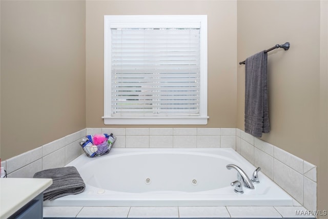 bathroom with vanity and tiled bath