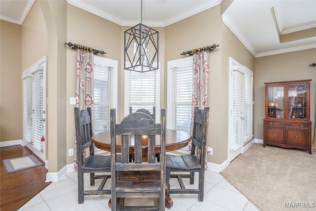 dining room with ornamental molding and light tile patterned floors