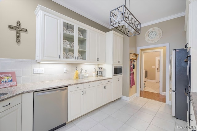 kitchen featuring crown molding, white cabinets, pendant lighting, and appliances with stainless steel finishes