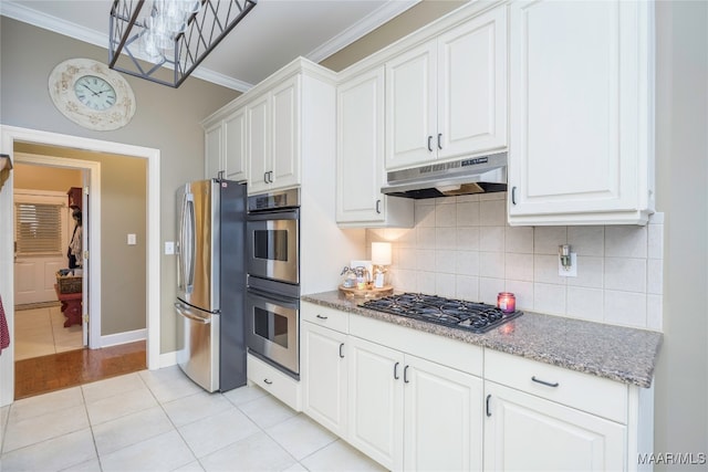 kitchen with stainless steel appliances, light tile patterned floors, decorative backsplash, white cabinets, and ornamental molding