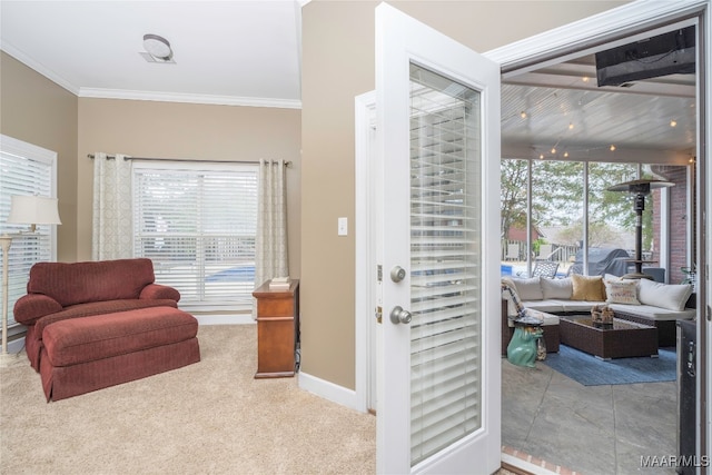 sitting room with carpet floors and ornamental molding