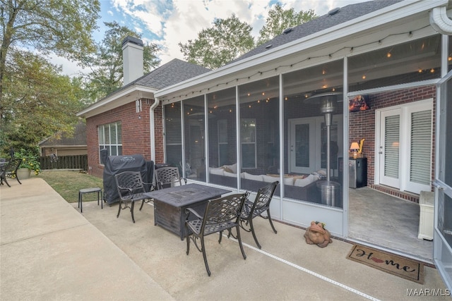 view of patio featuring a sunroom