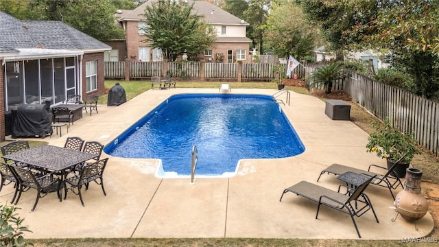 view of pool featuring a sunroom and a patio