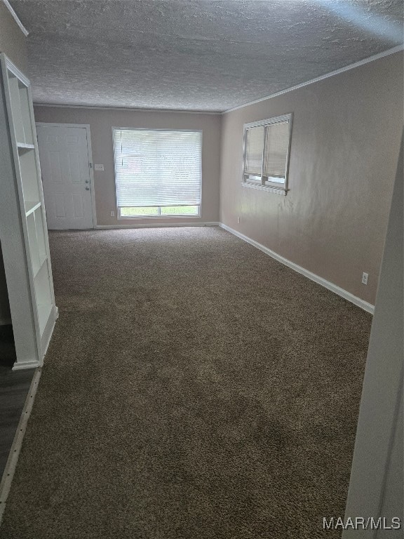 empty room featuring dark colored carpet and a textured ceiling