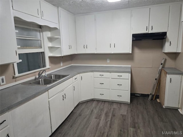 kitchen with white cabinetry, sink, a textured ceiling, and dark hardwood / wood-style floors