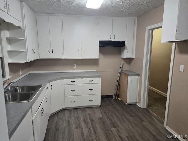 kitchen featuring dark hardwood / wood-style floors, sink, a textured ceiling, and white cabinets