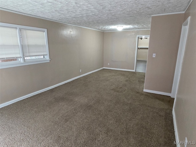 carpeted empty room with a textured ceiling