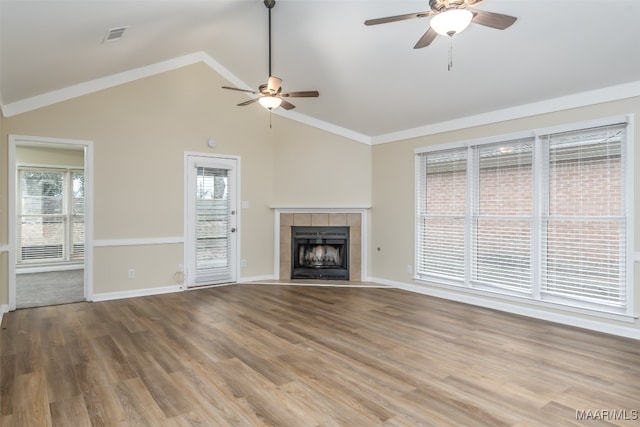 unfurnished living room featuring hardwood / wood-style flooring, ceiling fan, and a healthy amount of sunlight