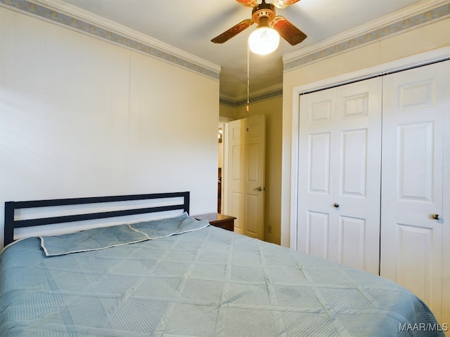 bedroom featuring a closet, ceiling fan, and crown molding