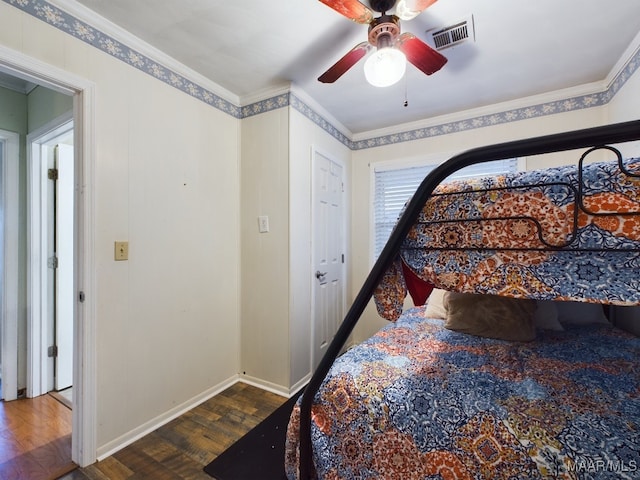 bedroom with ceiling fan, dark hardwood / wood-style floors, and ornamental molding