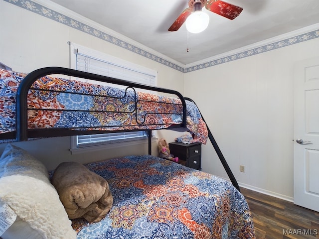 bedroom with dark hardwood / wood-style flooring, ceiling fan, and crown molding