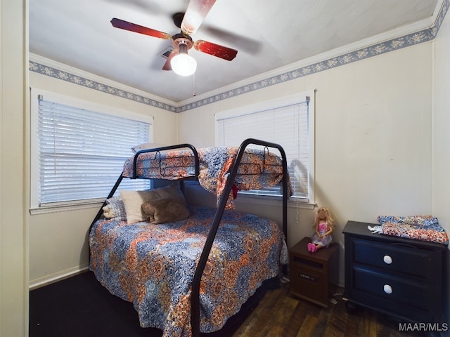 bedroom featuring ceiling fan, dark wood-type flooring, and ornamental molding