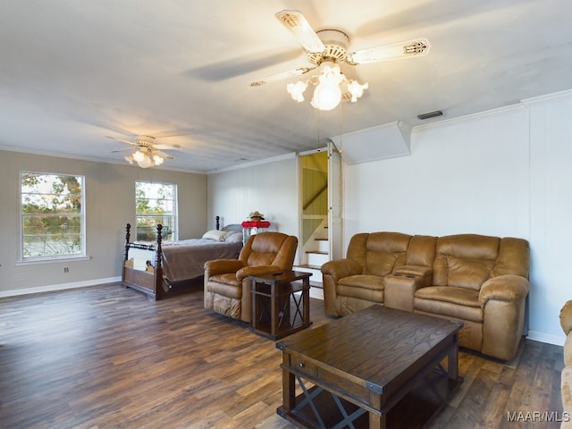 bedroom with dark hardwood / wood-style flooring, ceiling fan, and crown molding