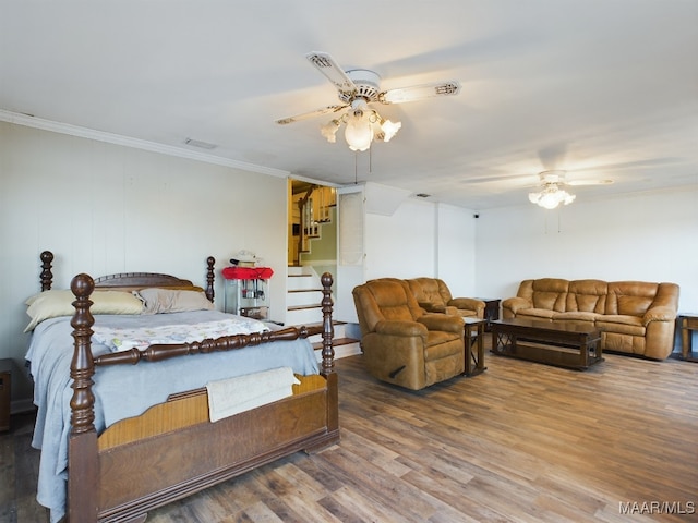 bedroom with ceiling fan, crown molding, and hardwood / wood-style flooring