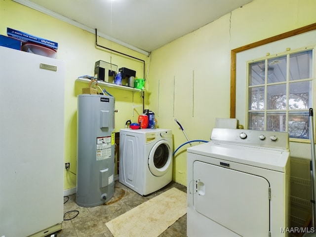 clothes washing area featuring independent washer and dryer and electric water heater