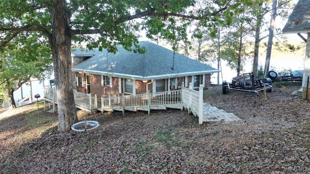 983 Lake Haven Dr, Deatsville, AL 36022 - rear view of house with brick siding, a shingled roof, and a deck