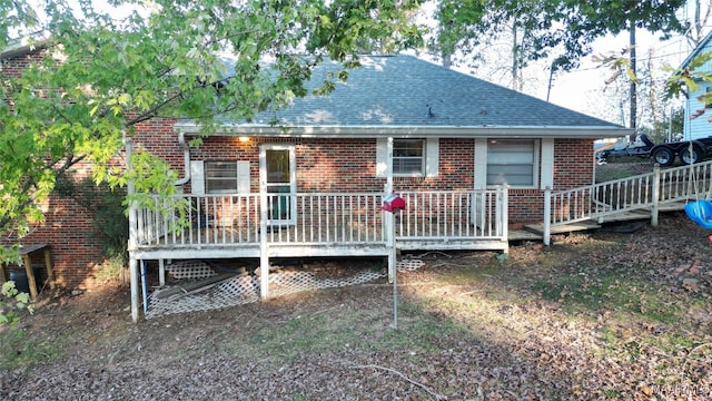 rear view of property with a wooden deck