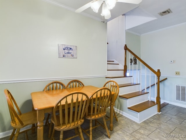 dining space featuring ceiling fan and crown molding