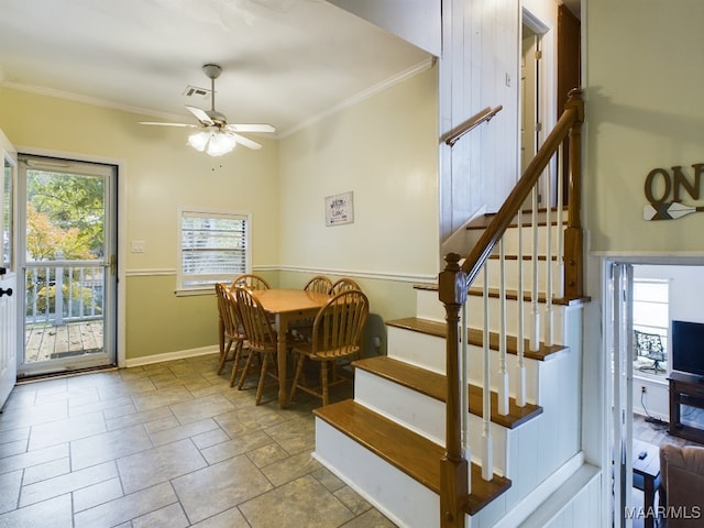 dining area with ceiling fan and crown molding