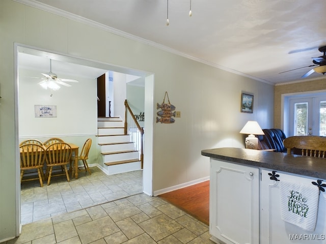 kitchen with white cabinets, french doors, ceiling fan, and ornamental molding