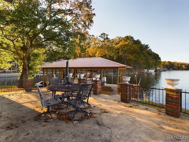 view of patio featuring a boat dock and a water view