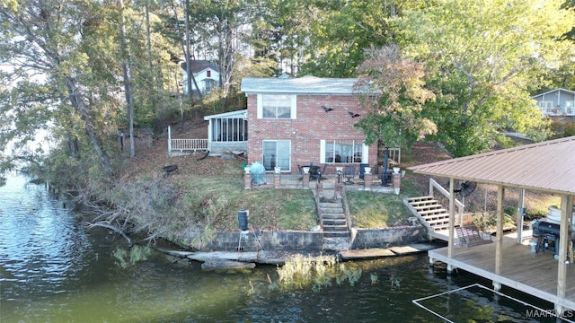 exterior space featuring a water view and a patio