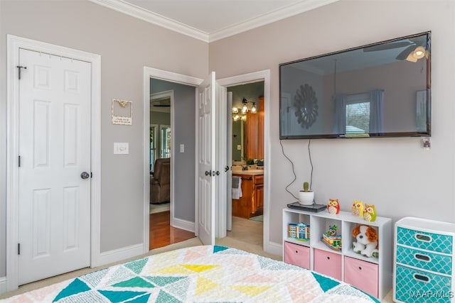 bedroom with connected bathroom and crown molding