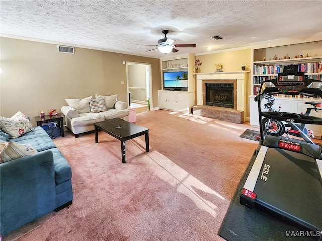 carpeted living room featuring ceiling fan, a textured ceiling, and ornamental molding