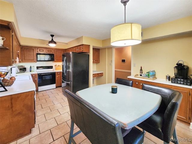 kitchen with ceiling fan, sink, hanging light fixtures, white range with electric cooktop, and stainless steel fridge