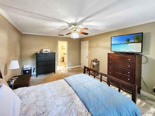 bedroom featuring ceiling fan, ornamental molding, a textured ceiling, and connected bathroom