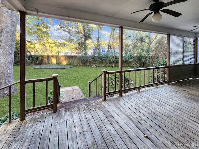 wooden deck with a yard and ceiling fan