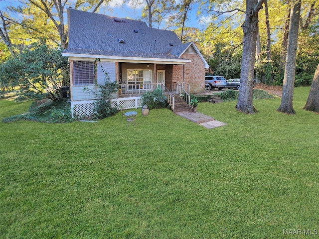 back of house featuring covered porch and a yard