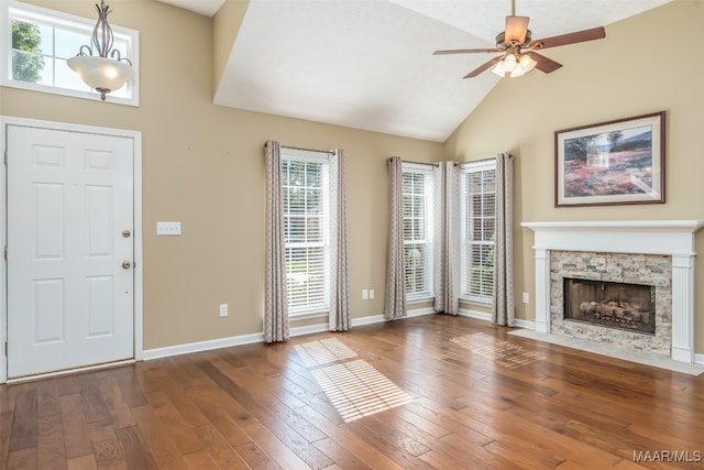 unfurnished living room featuring a fireplace, dark hardwood / wood-style flooring, and plenty of natural light