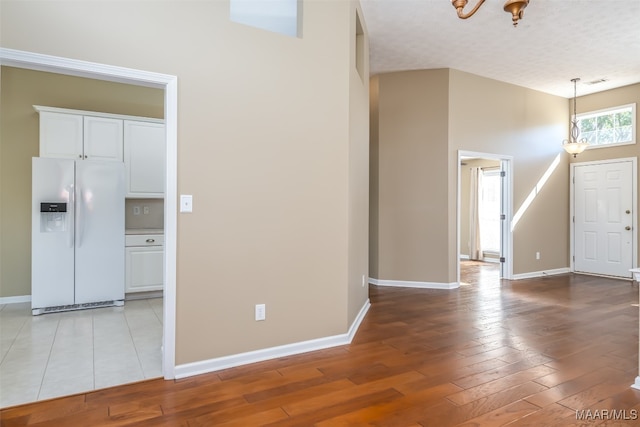 interior space featuring a textured ceiling and light wood-type flooring