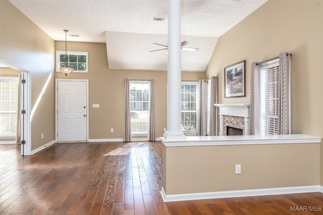 entrance foyer featuring lofted ceiling, ornate columns, ceiling fan, and dark wood-type flooring