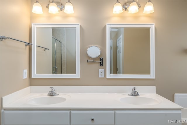 bathroom with vanity and a shower with shower door