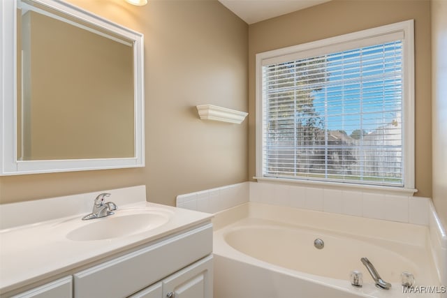 bathroom featuring vanity, plenty of natural light, and a bathing tub