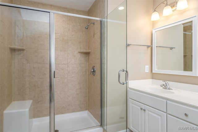 bathroom with vanity and a shower with shower door