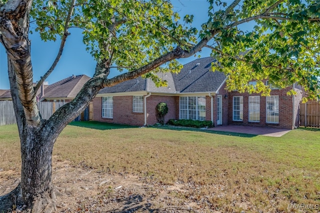 ranch-style home with a patio and a front lawn