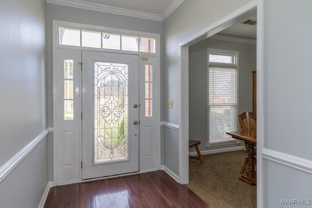 foyer featuring a healthy amount of sunlight, crown molding, and dark wood-type flooring