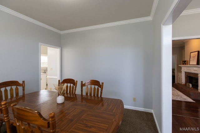 dining space featuring carpet flooring, crown molding, and a fireplace