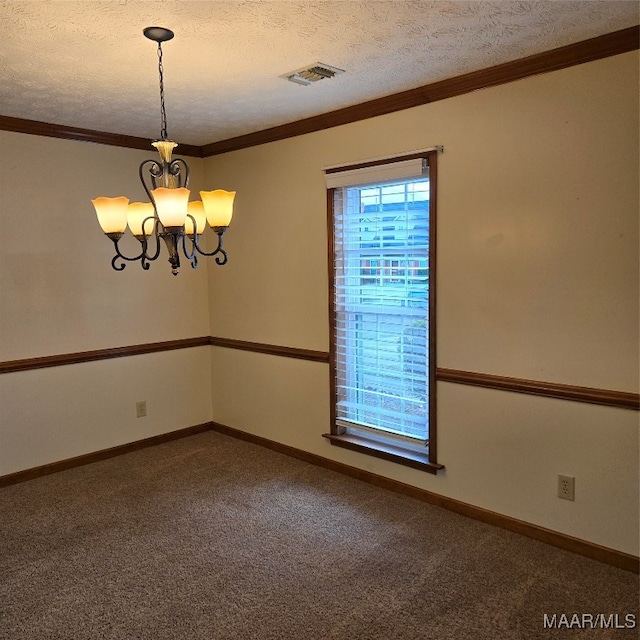 carpeted empty room featuring crown molding, a chandelier, and a textured ceiling